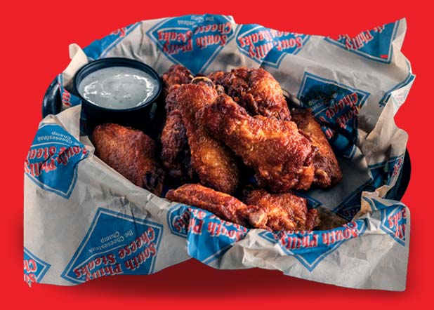 Basket of golden fried chicken wings and drumsticks served at South Philly Cheese Steaks, Colorado's best restaurant